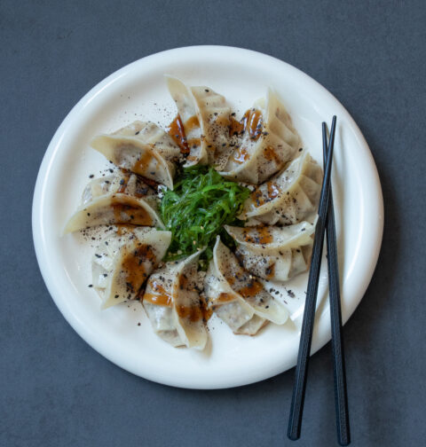 Homemade Gyoza with Mushroom and Smoked Tofu Filling served with Seaweed Salad